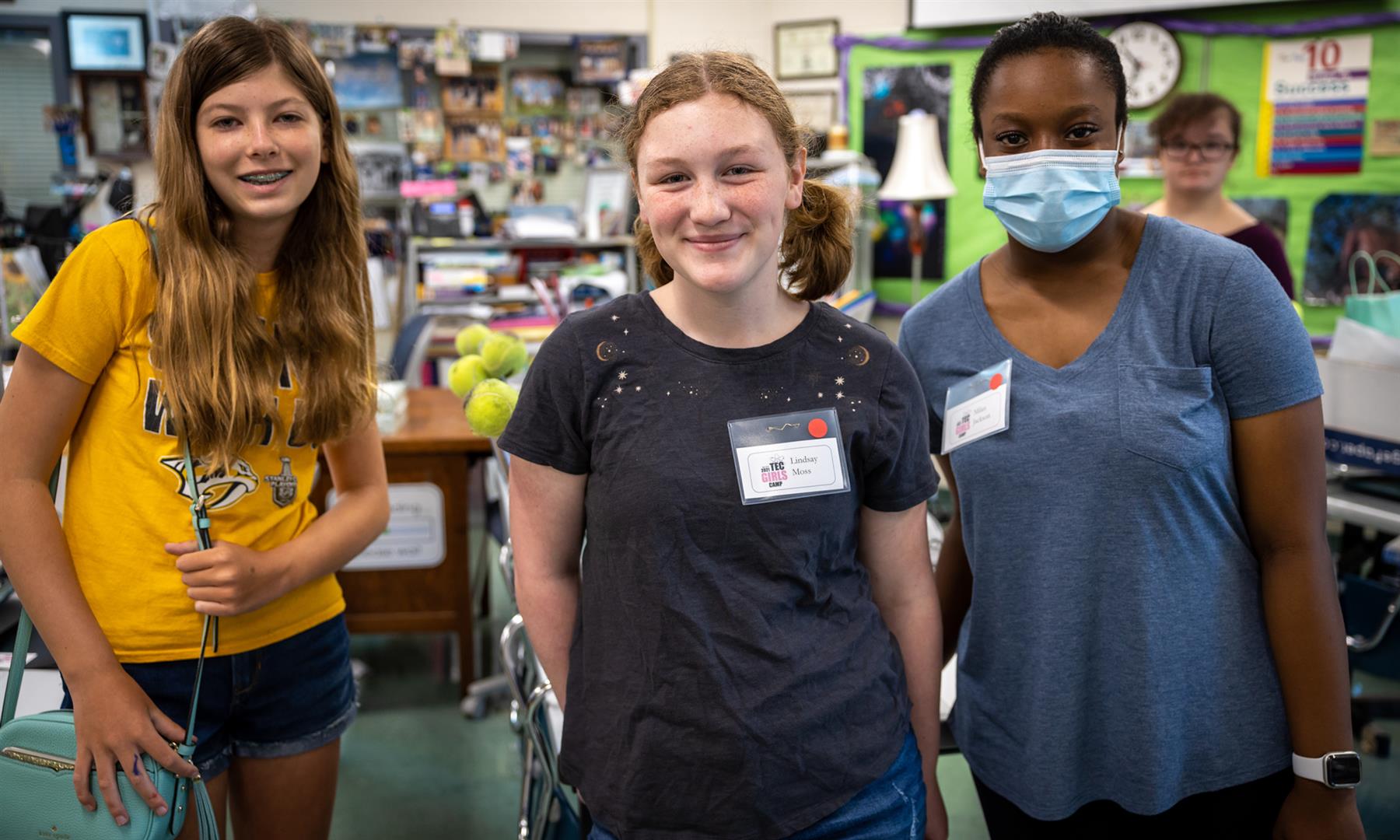Three girls smile
